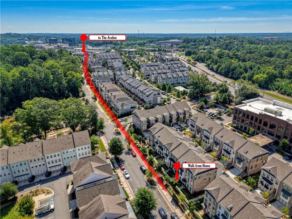 Aerial view of townhouses with a red walking route marked toward The Avalon.