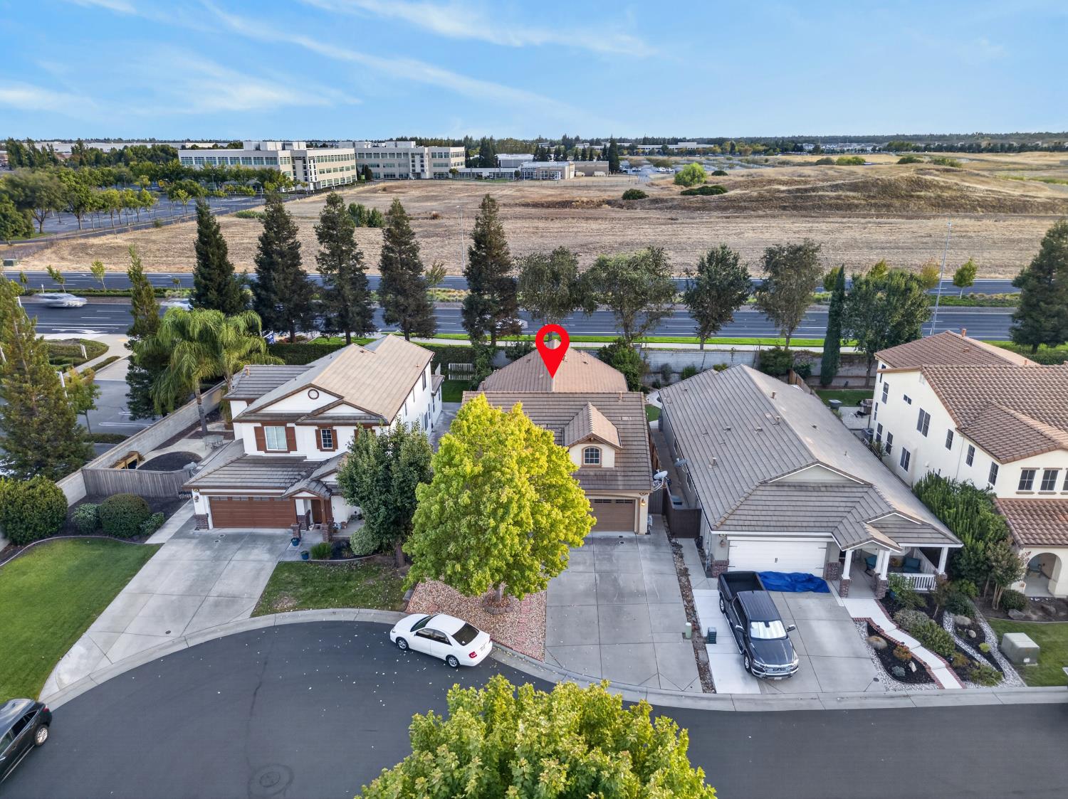 Aerial view of 124 Laysan Teal Court, marked with a red pin among neighboring homes.