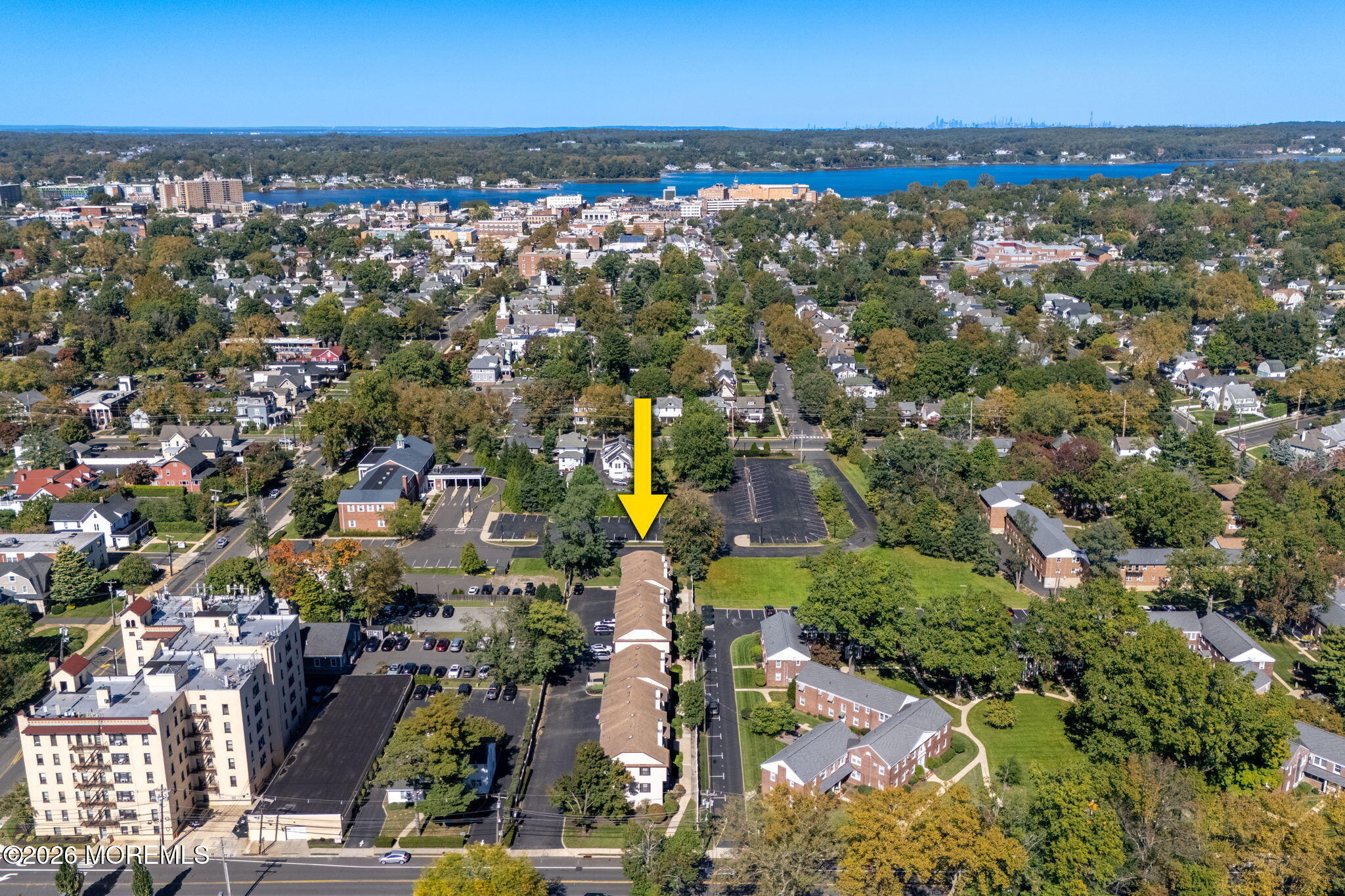 Aerial view of the property, marked by a yellow arrow, with Red Bank and a waterway in the distance.