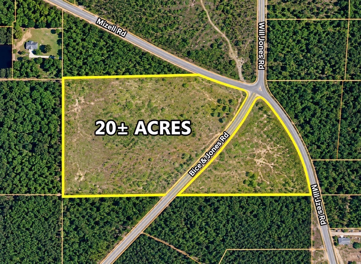 Aerial view of a cleared 20-plus-acre parcel outlined in yellow where three roads meet.