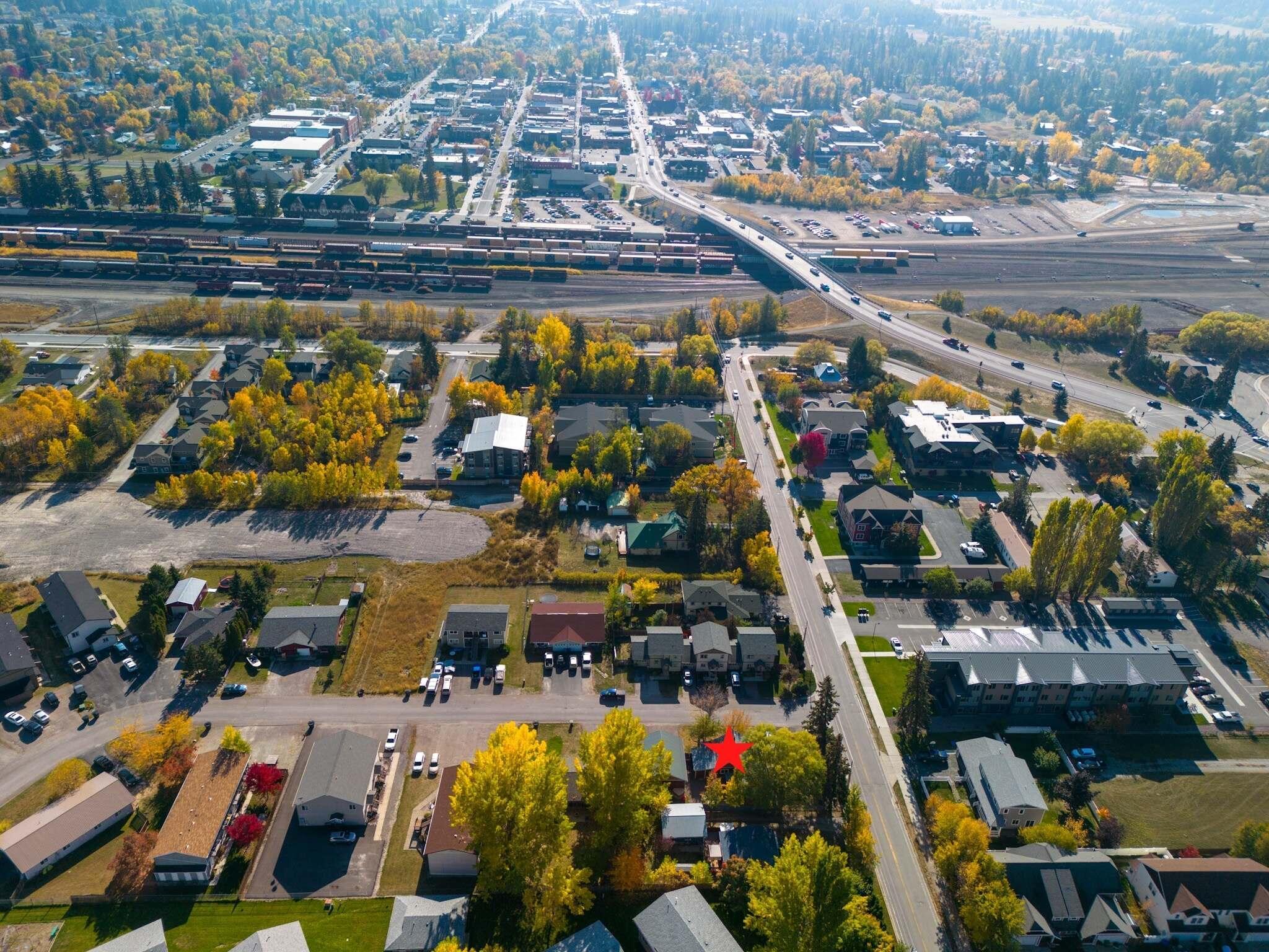 Aerial view of the Whitefish neighborhood, with the property marked by a red star near railroad tracks.