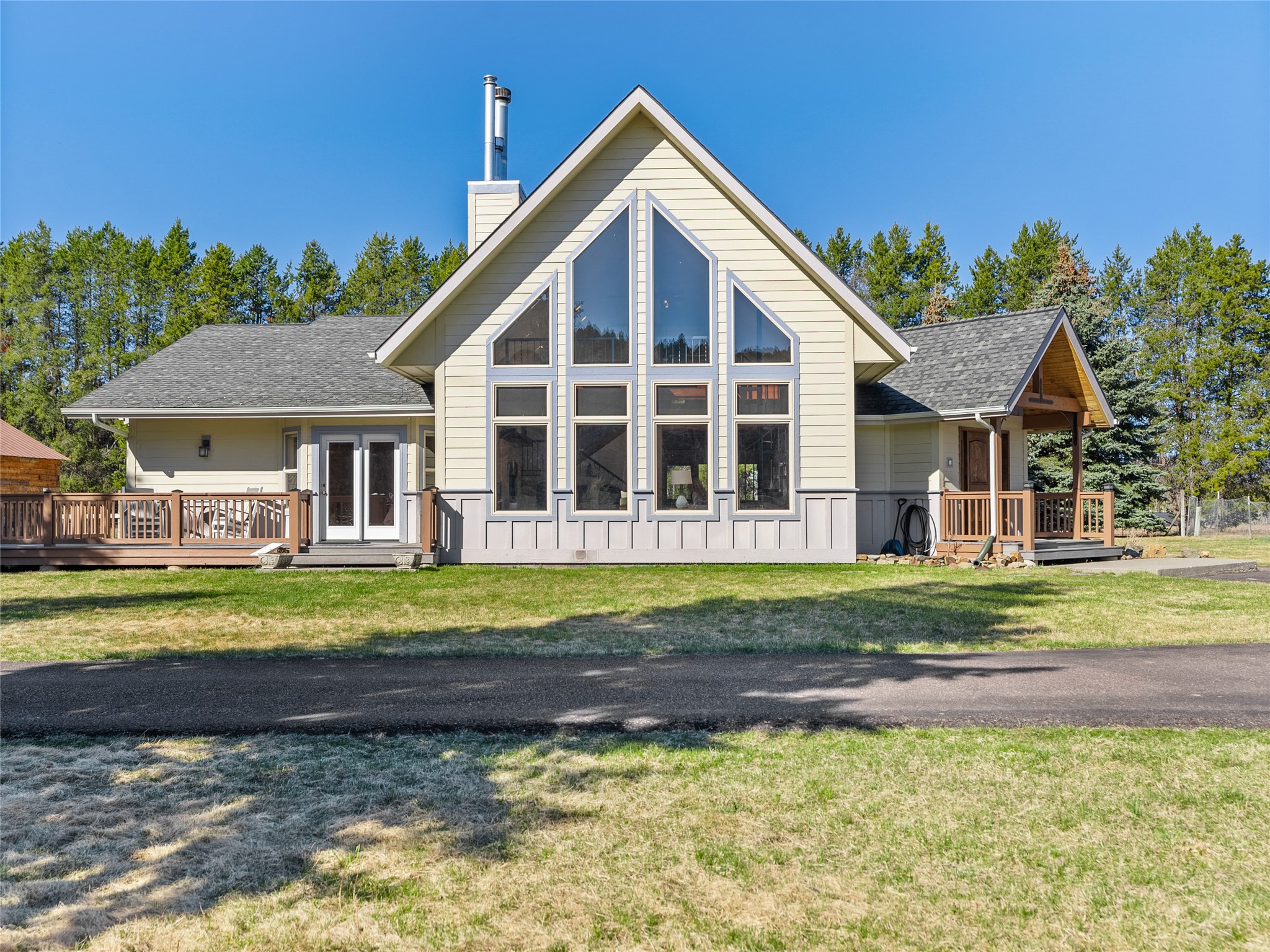 House with a steep gable, tall windows, and raised wooden decks