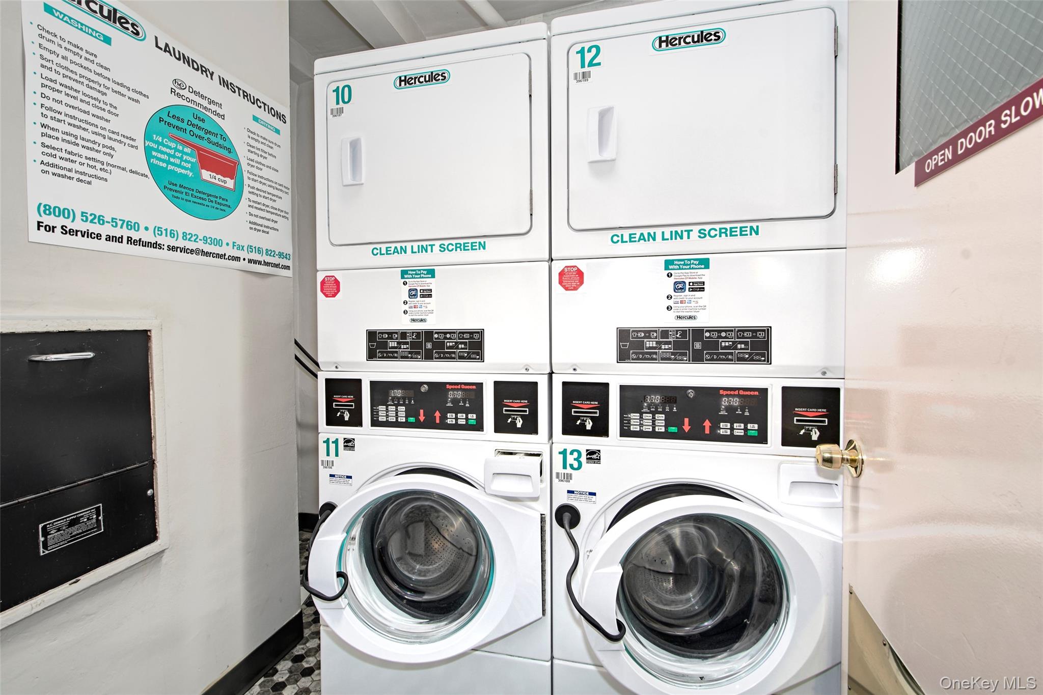 Shared laundry room with two stacked washer-and-dryer units and posted laundry instructions.