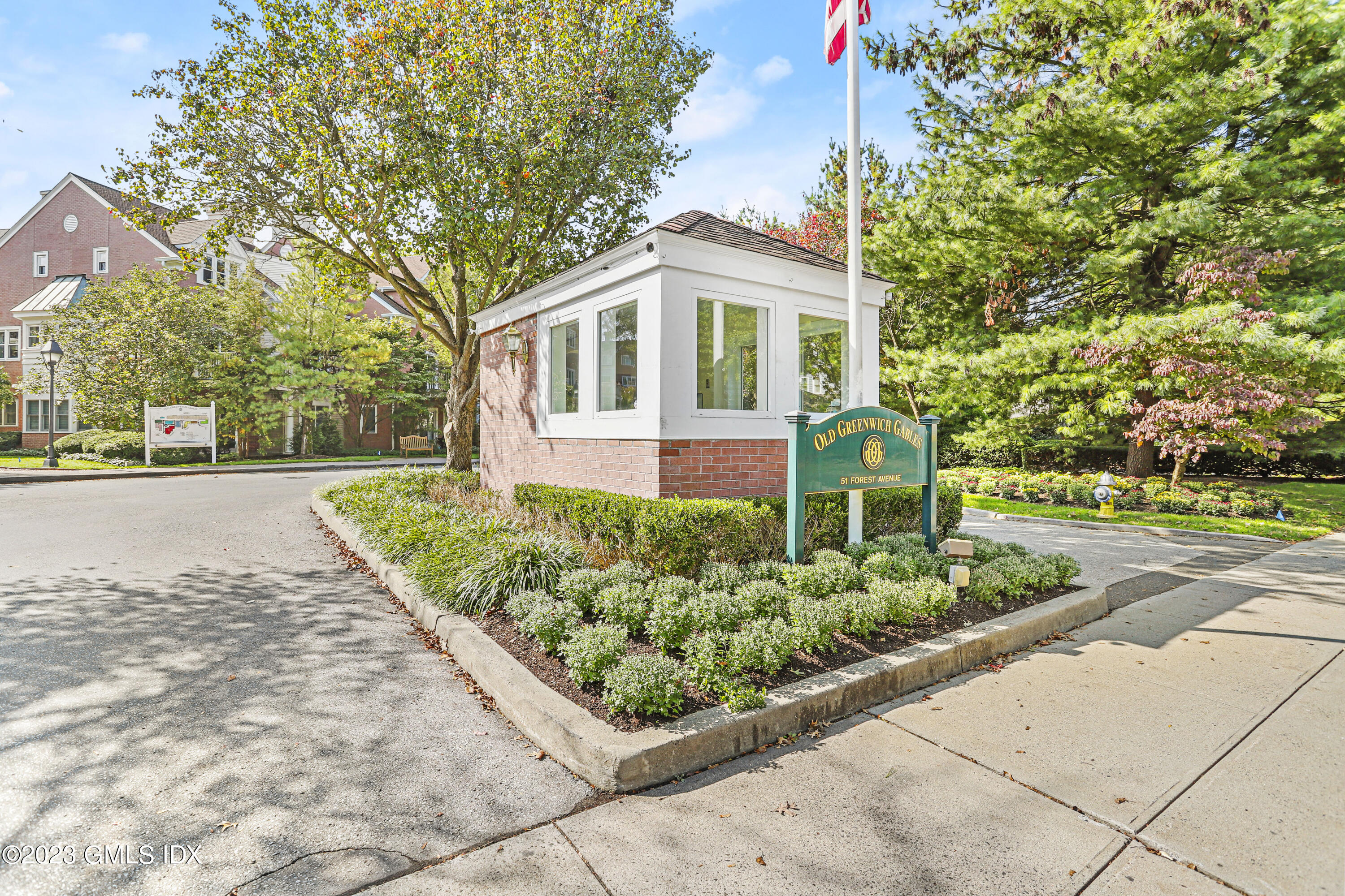 Old Greenwich Gables entrance with a brick guardhouse and landscaped grounds.