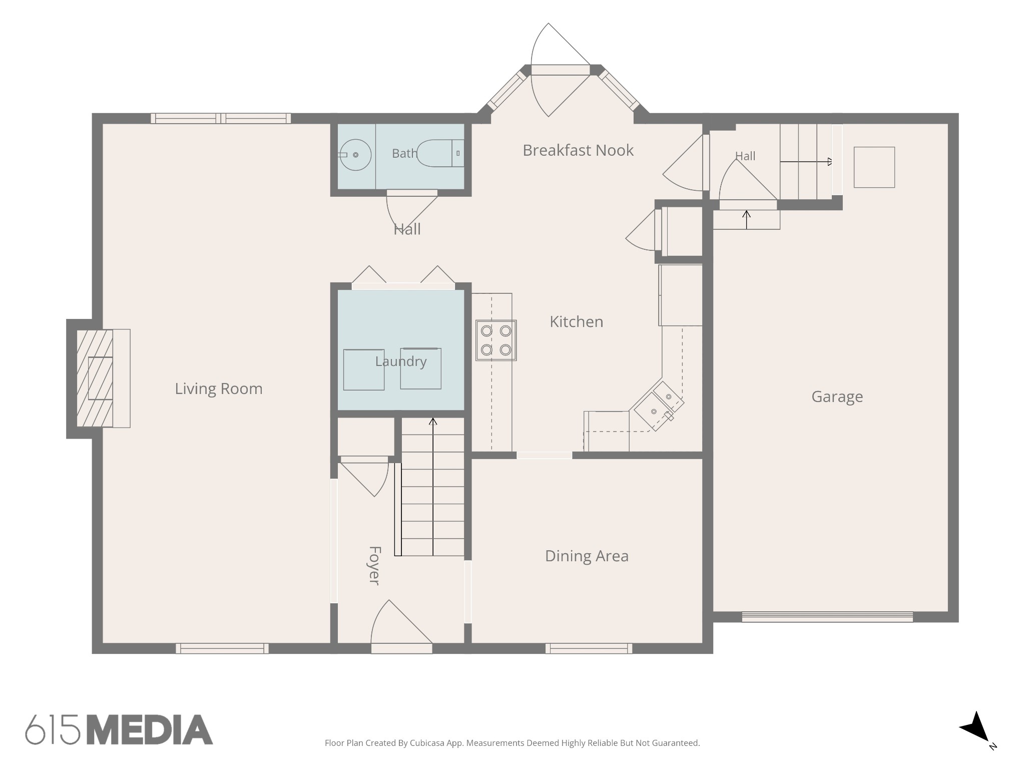Floor plan showing the living room, kitchen, dining area, laundry, bath, foyer, and attached garage.