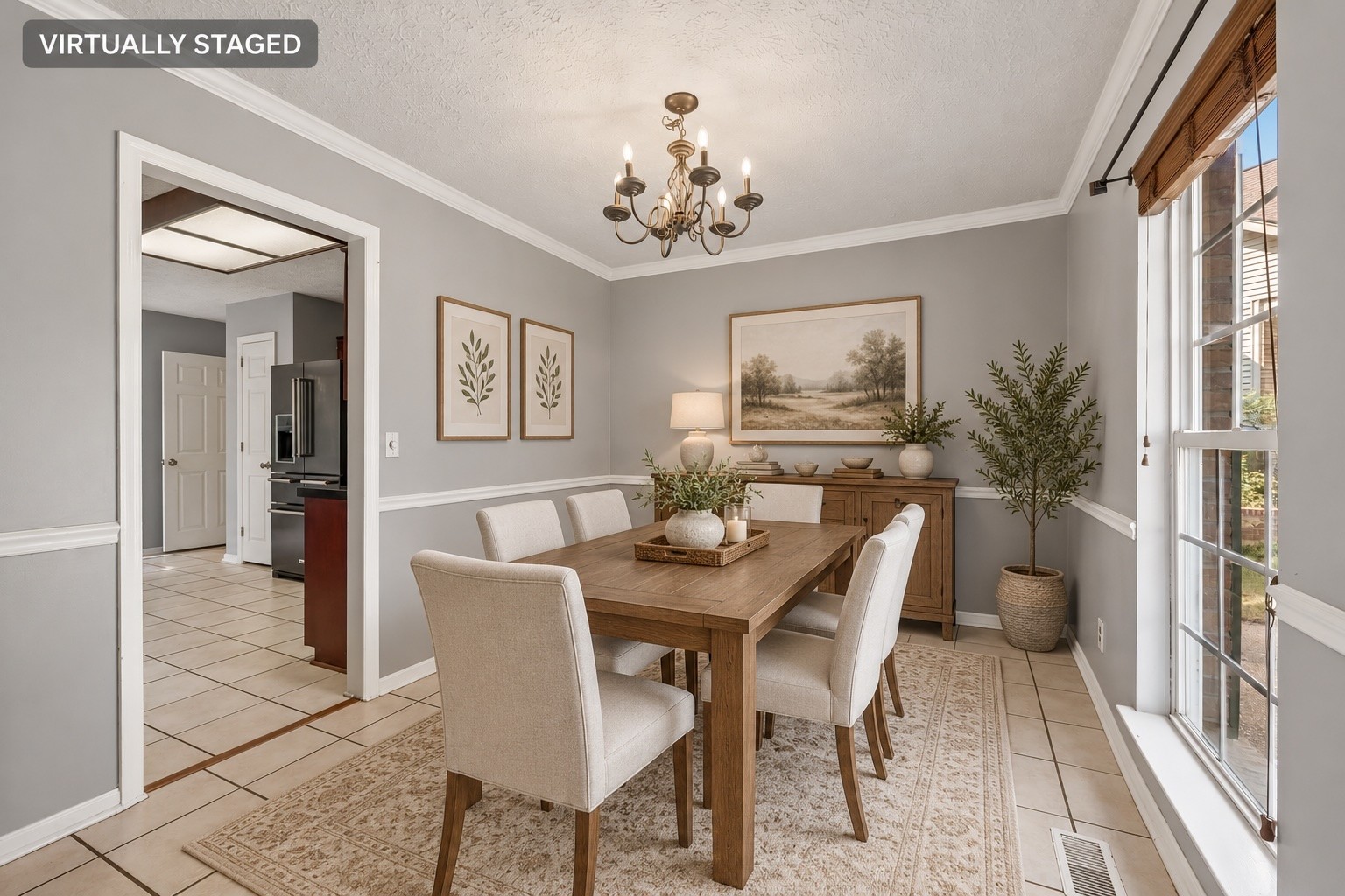 Dining room with a wooden table, upholstered chairs, chandelier, and large windows.