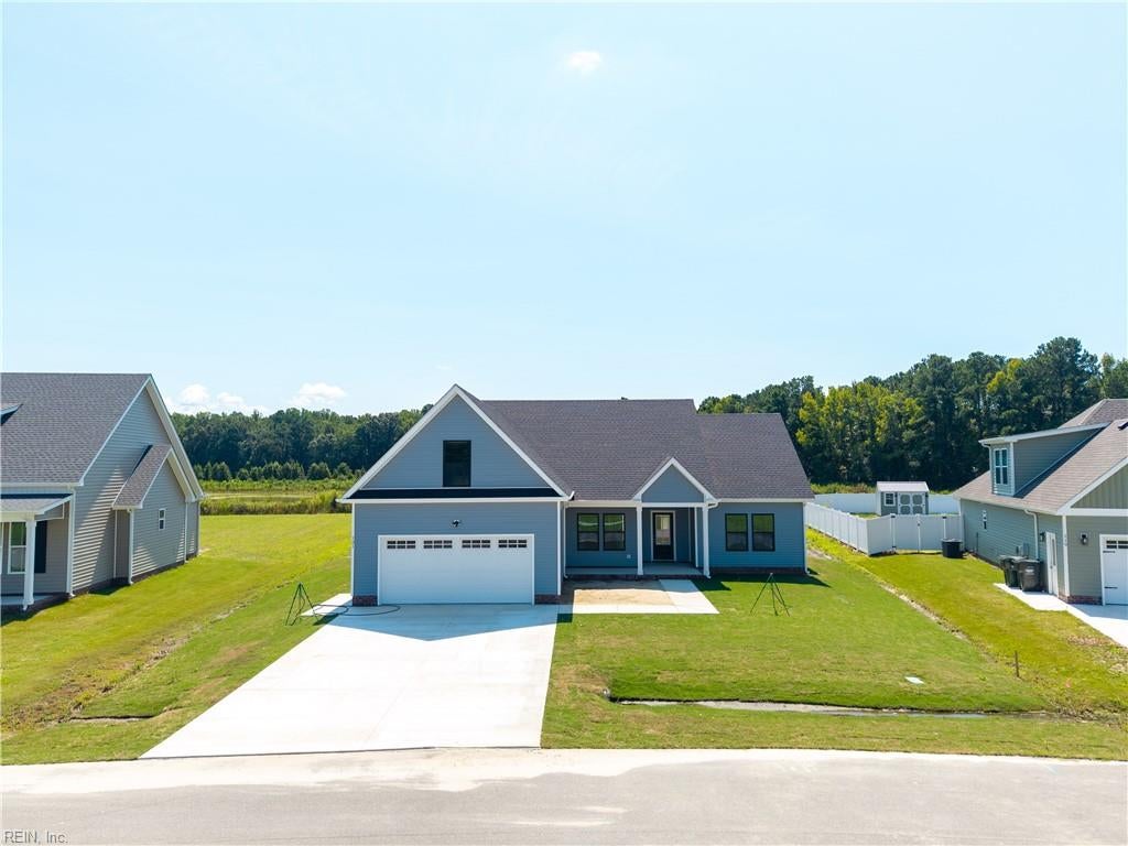 Blue single-story house with an attached two-car garage and wide driveway.