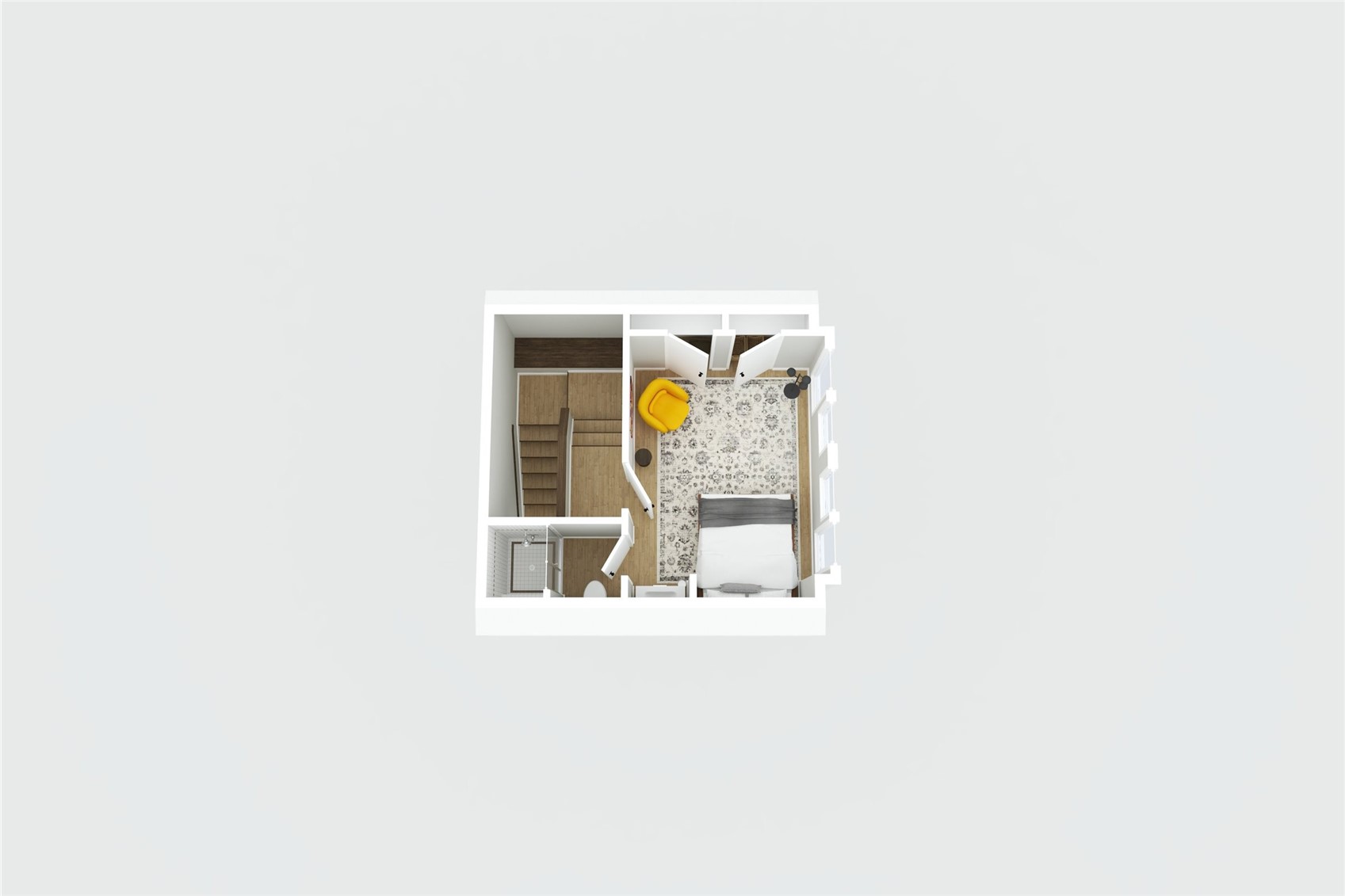Floor plan of a bedroom with a yellow chair, bathroom, and staircase.