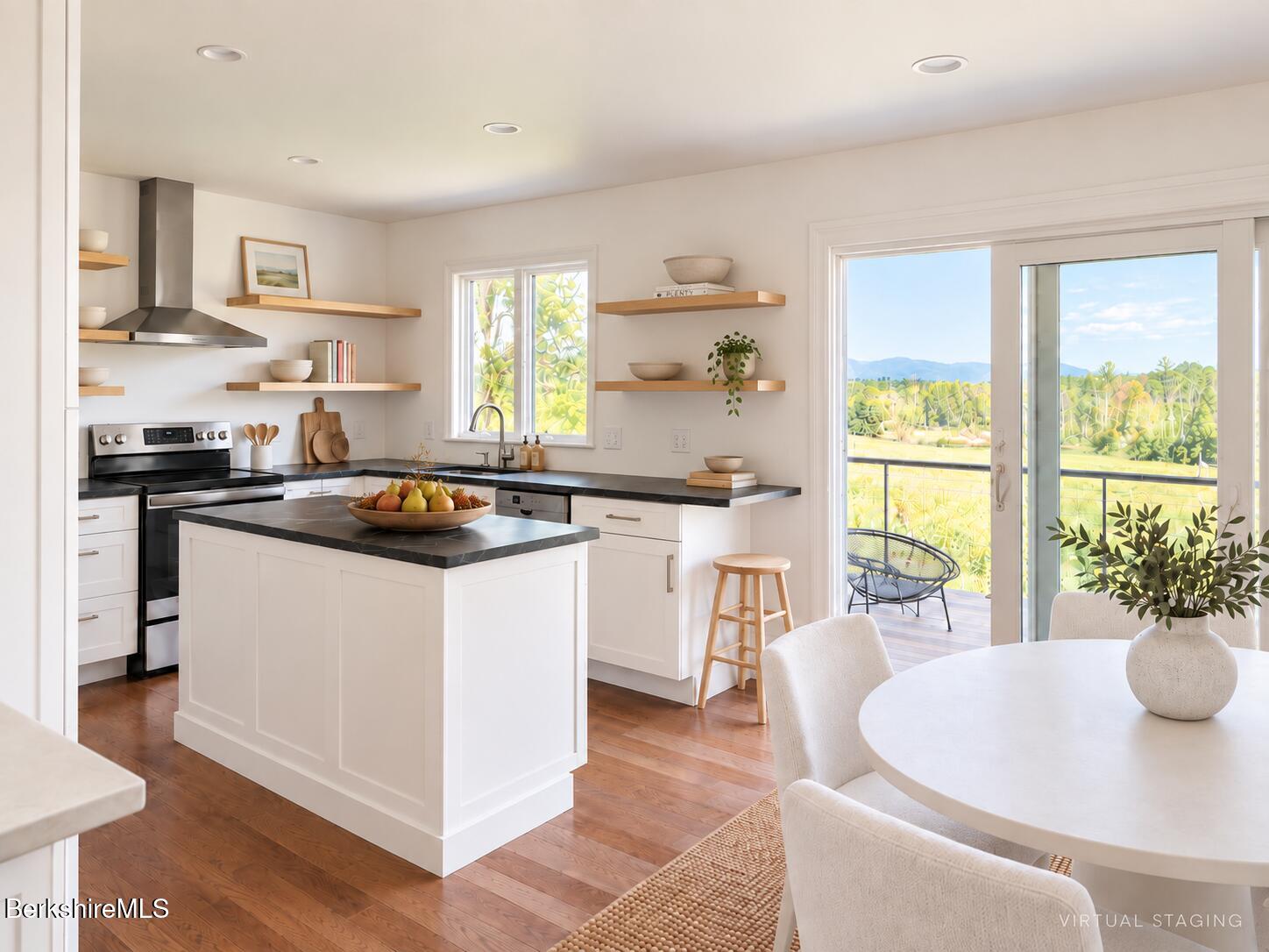 Bright staged kitchen with a dark-counter island, open shelves, and sliding doors to a balcony.