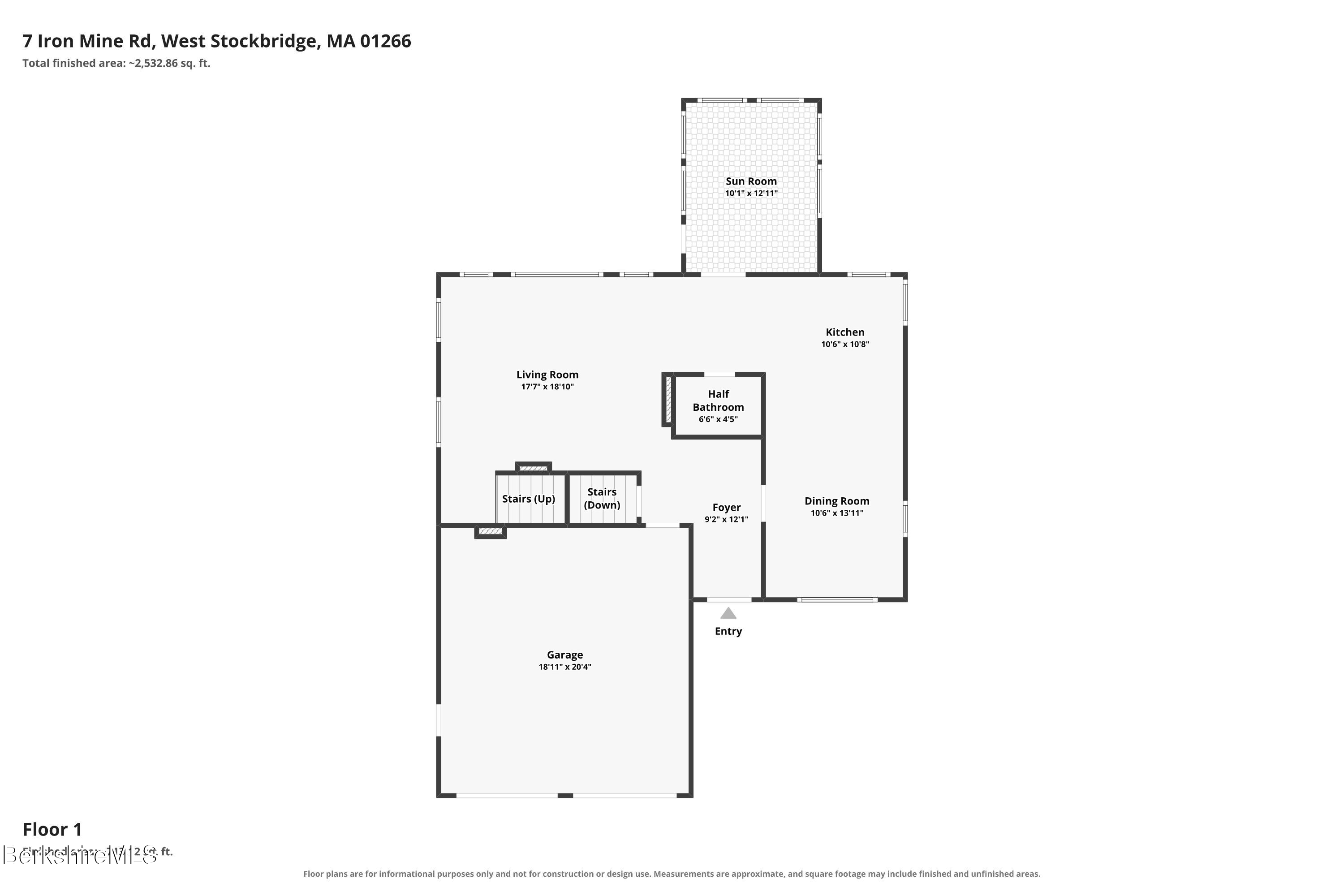 First-floor plan of 7 Iron Mine Rd showing a sun room, open living and dining areas, and attached garage.