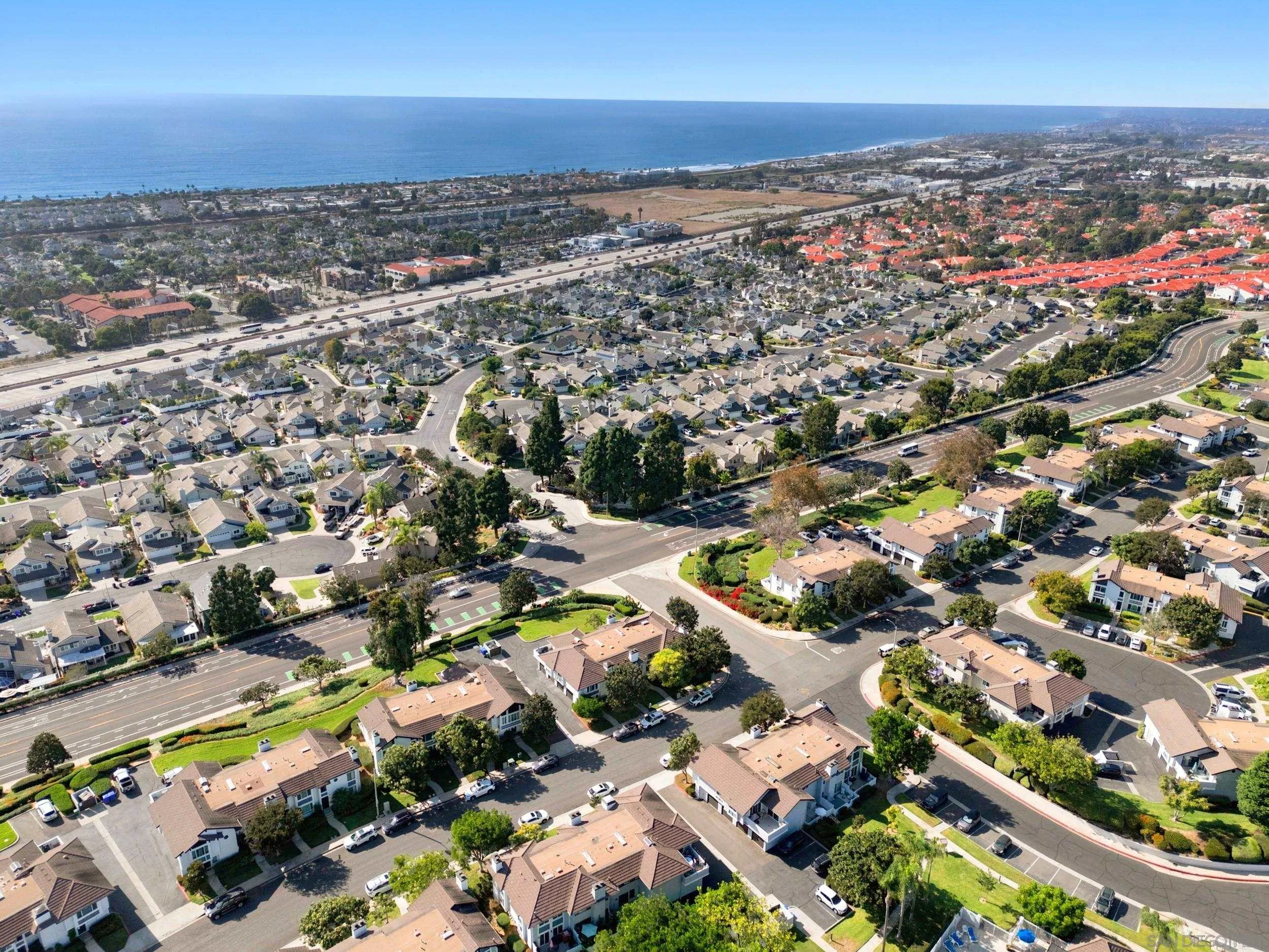 Aerial view of a coastal Carlsbad neighborhood, with the Pacific Ocean beyond.