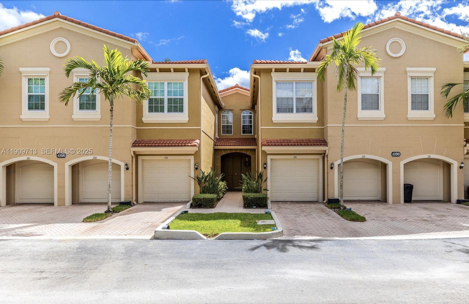 Townhomes at 4890 Bonsai Circle, with unit 106 centered beside the entrance walkway.