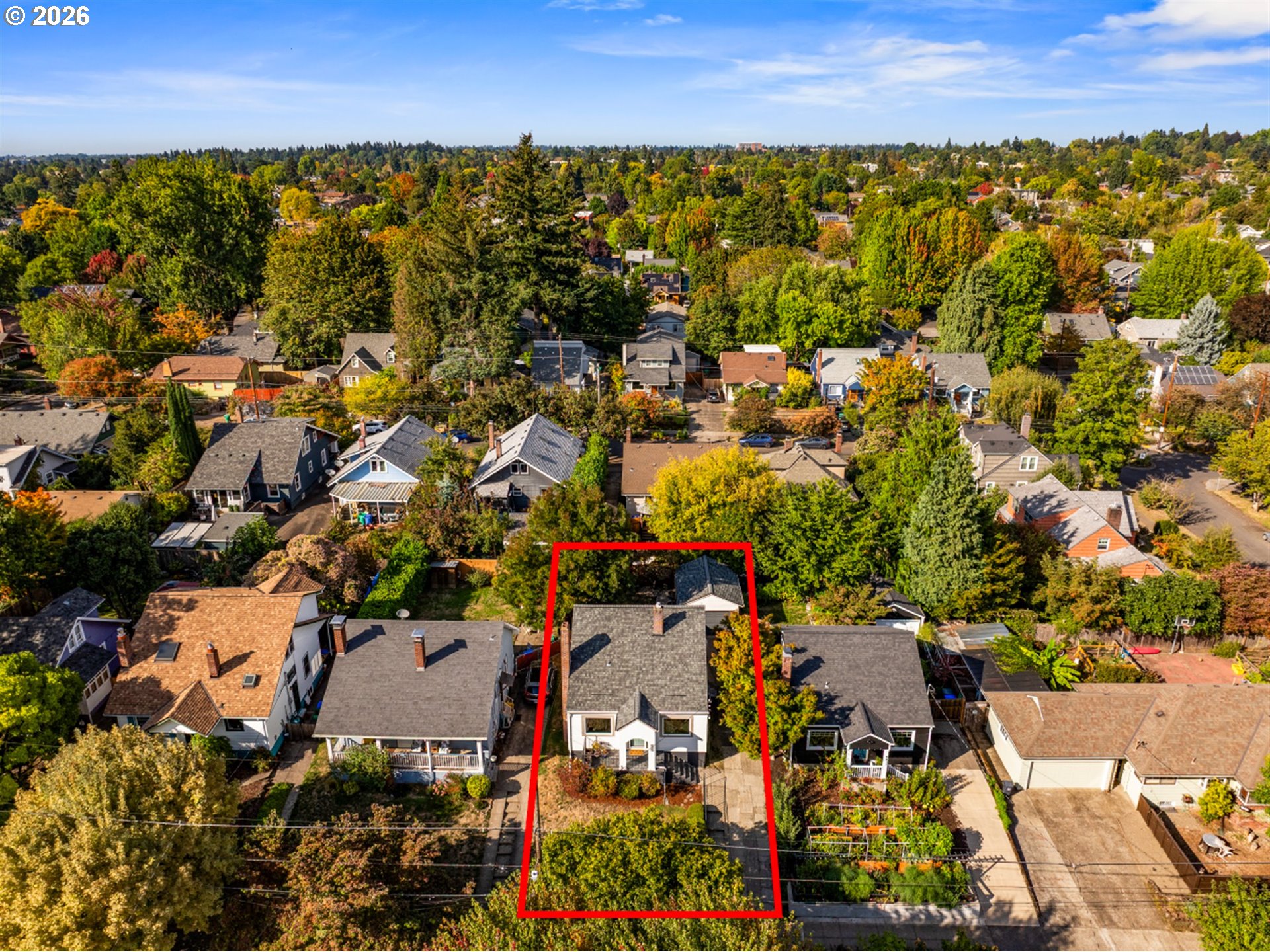 Aerial view of a house outlined in red among leafy Portland homes.