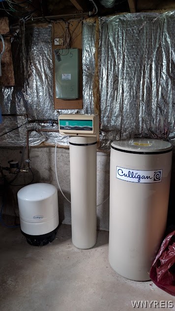 Basement water treatment system with Culligan tanks and reflective insulation.