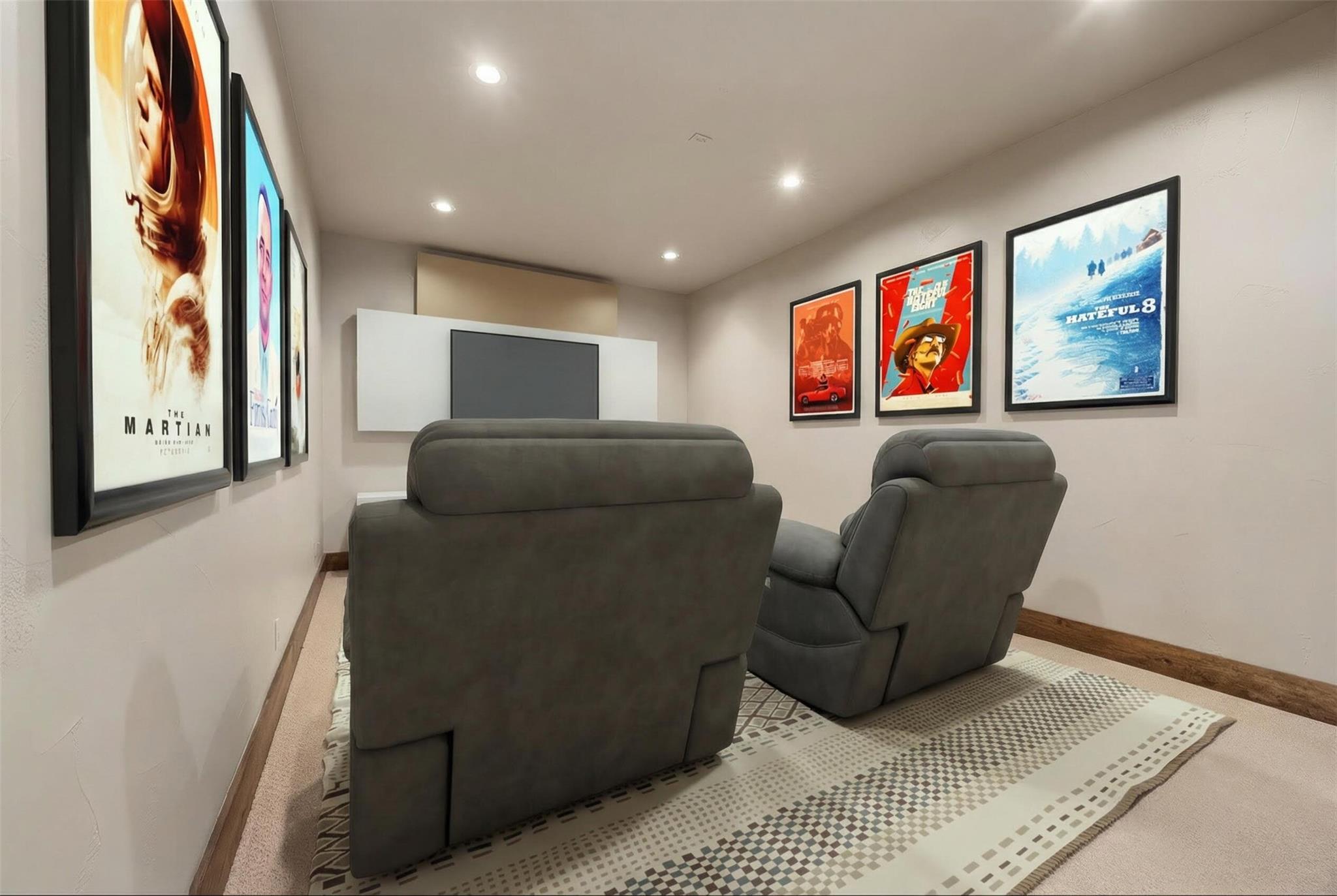 Home theater with gray recliners, a screen, and framed movie posters.