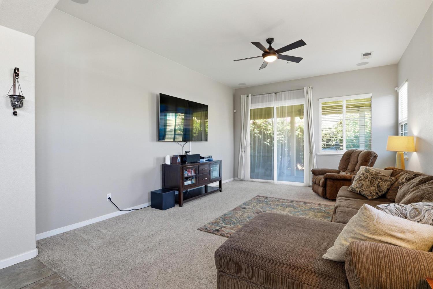 Furnished living room with a sectional sofa, recliner, and sliding doors to a patio.