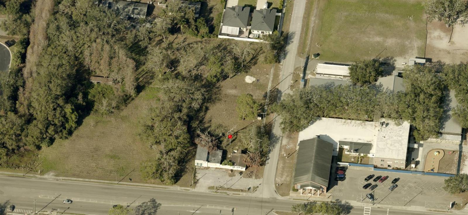 Aerial view of a wooded property beside Gunn Highway, marked with a red pin.
