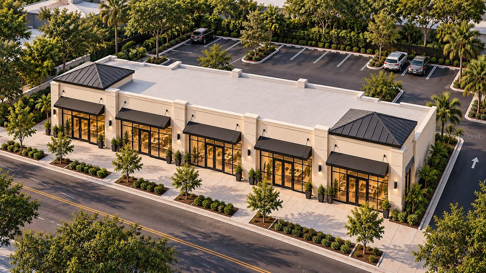 Aerial view of a retail building with black awnings, landscaped walkways, and a tree-lined parking lot.