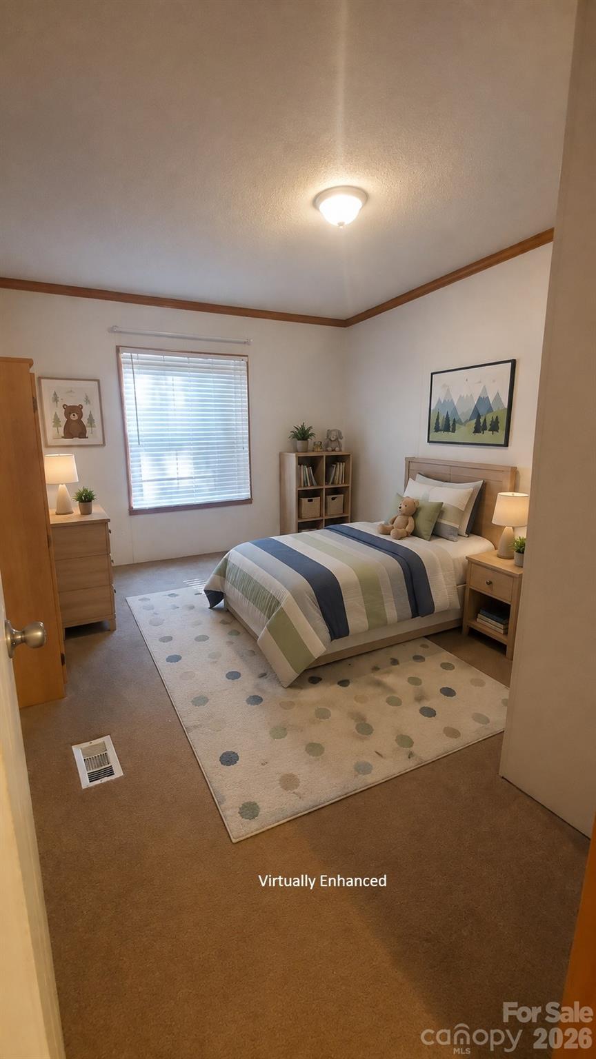 Bedroom with striped bedding, a polka-dot rug, and light wood furniture.