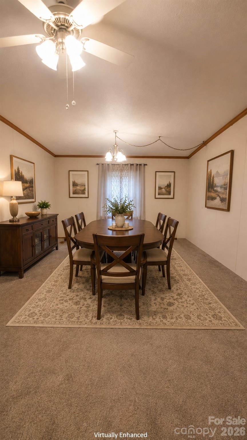 Furnished dining room with a dark wood table, patterned rug, and ceiling fans with lights.