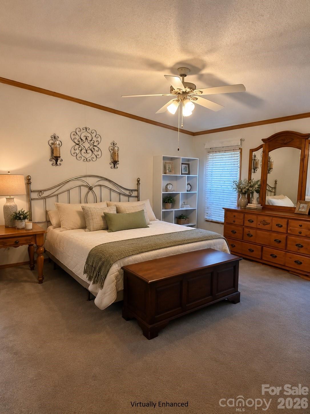 Furnished bedroom with cream bedding, a metal bed frame, and a large wooden dresser and mirror.