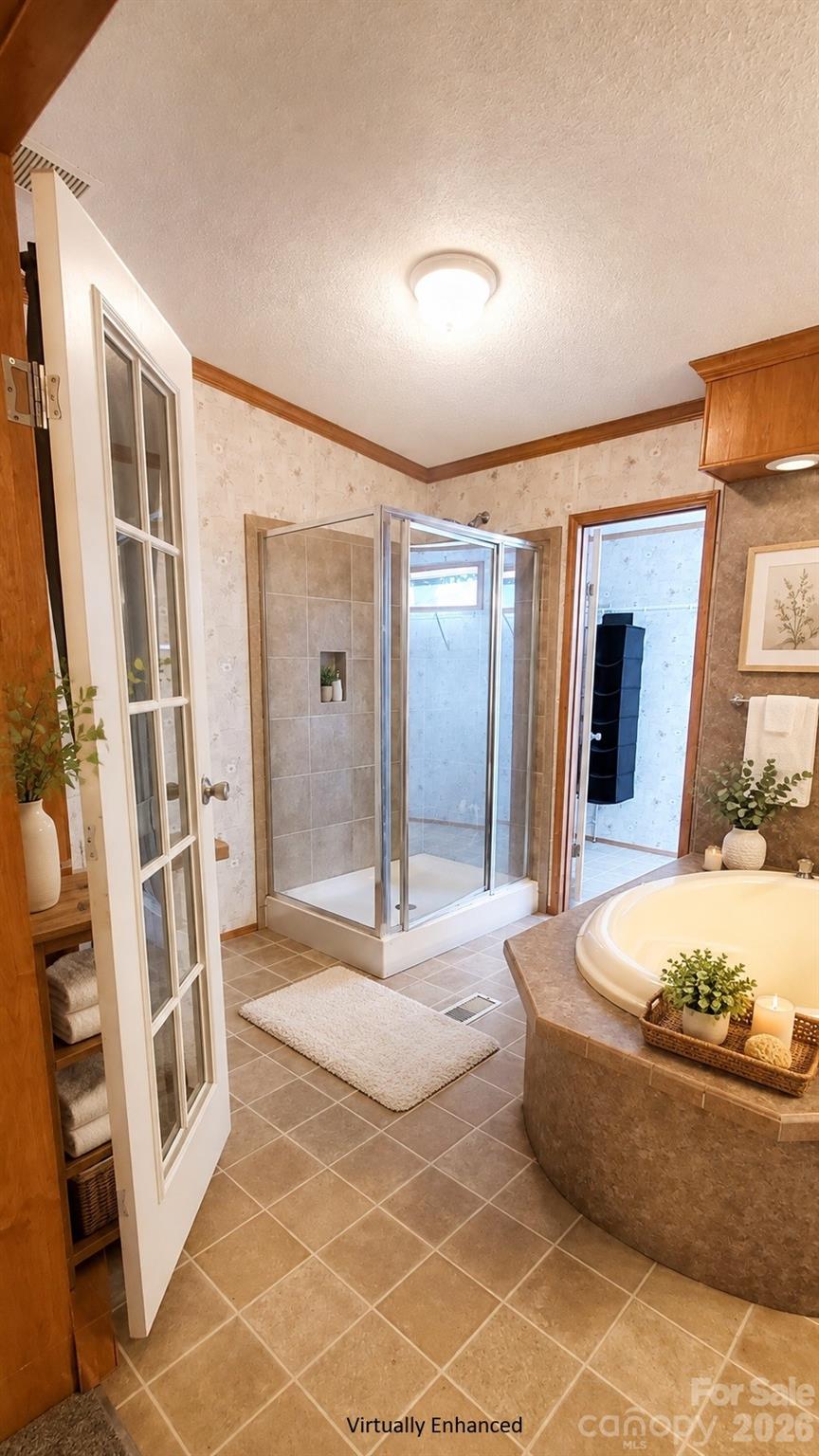 Bathroom with a corner soaking tub, glass shower, beige tile, and warm wood trim.