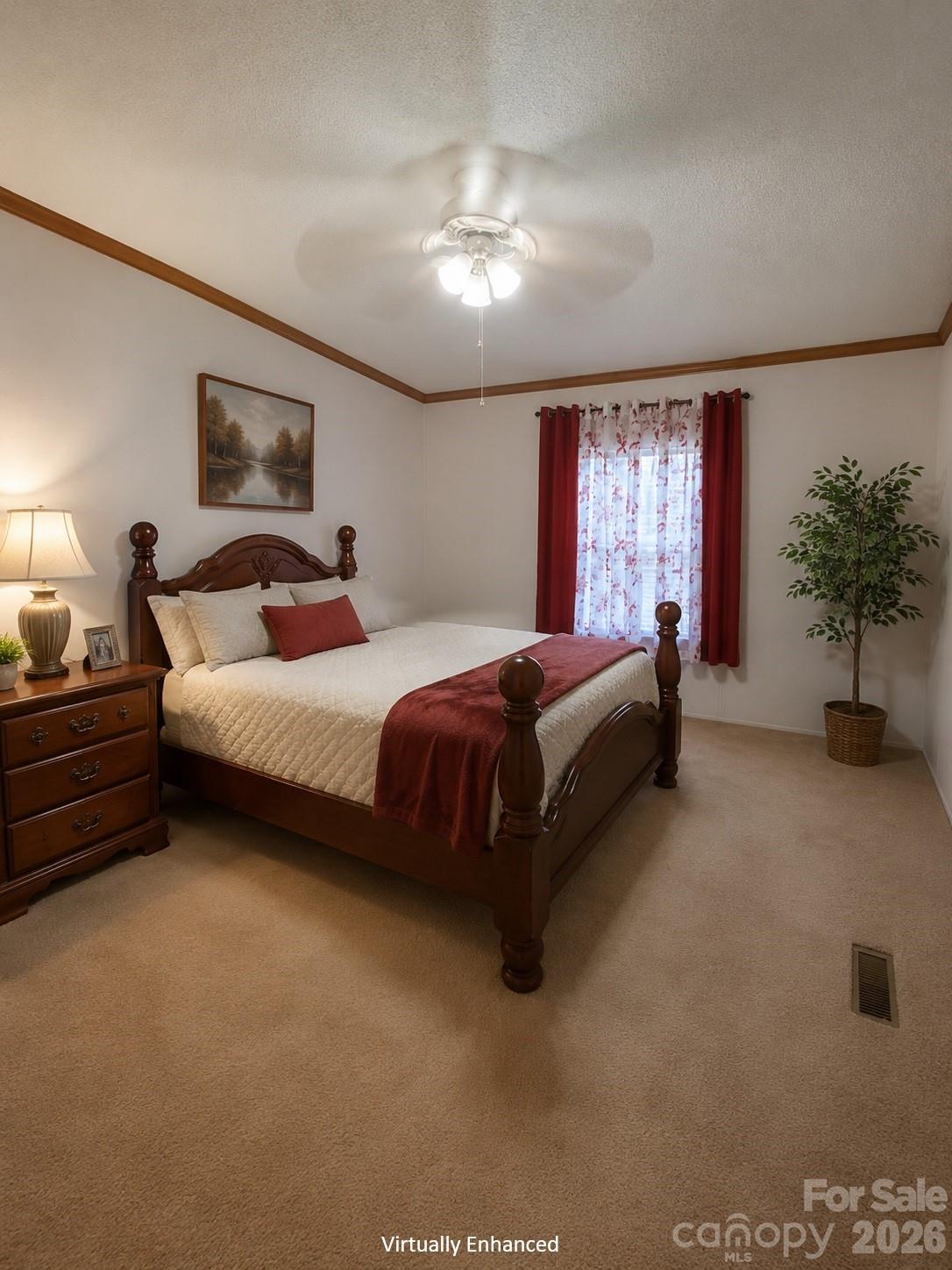 Bedroom with a dark wood four-poster bed, cream bedding, red curtains, and carpet.