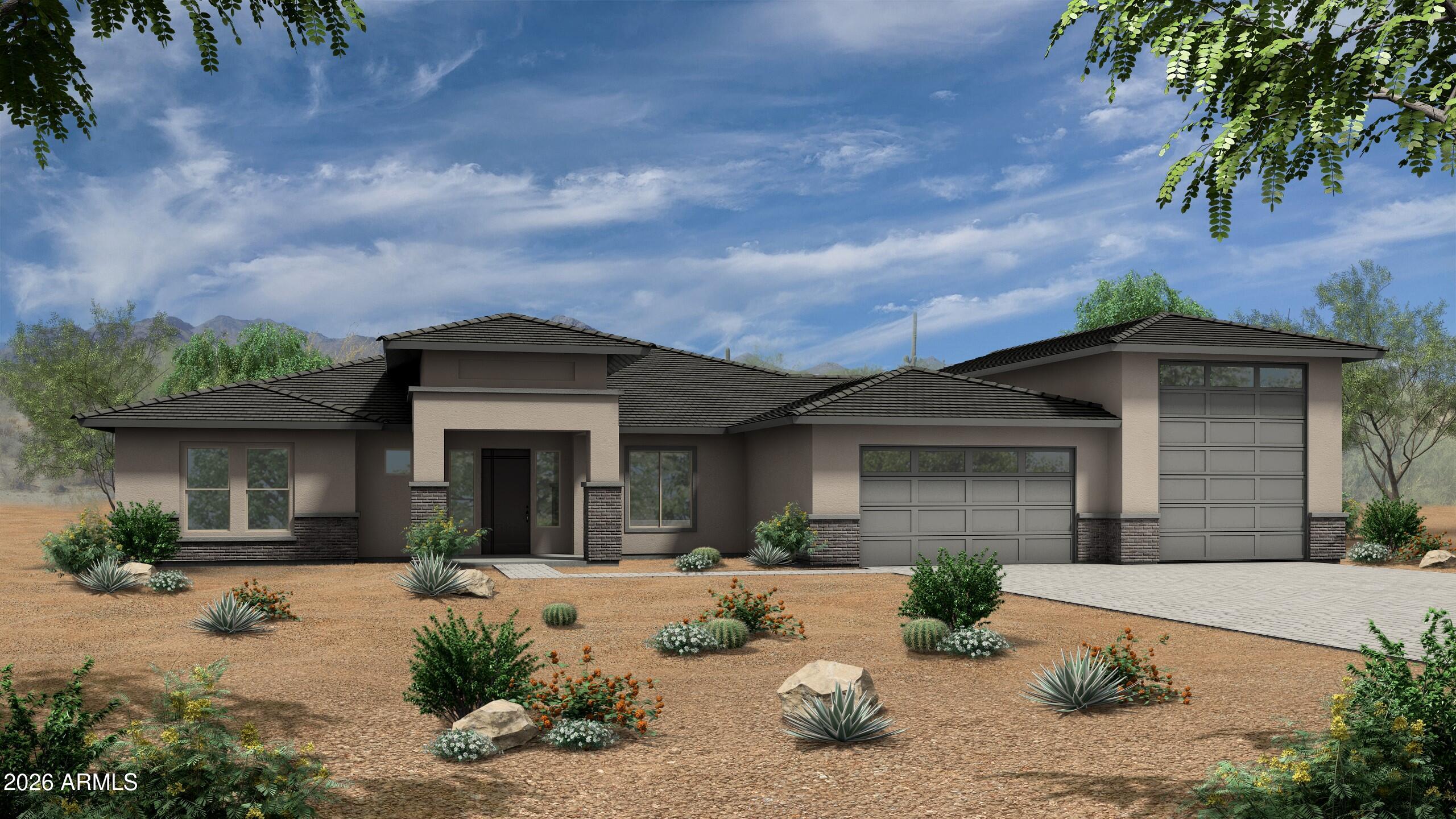 Modern Southwestern home with two garage doors, desert landscaping, and mountains in the background.