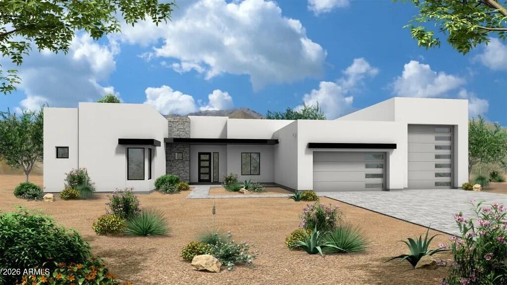 Modern white desert home with stone entry, two garage doors, and drought-tolerant landscaping.
