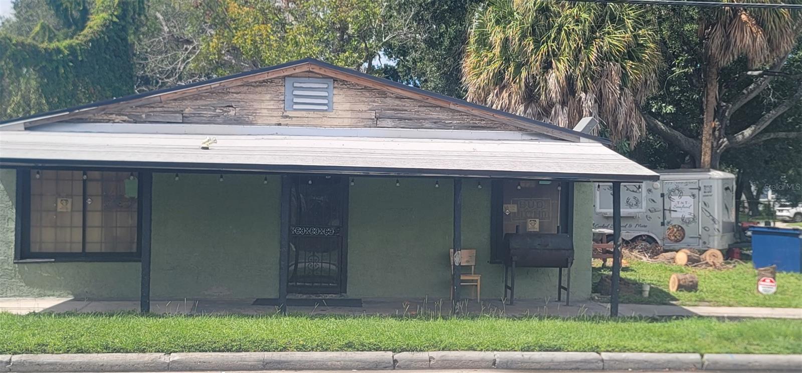 206 N Oregon Ave, a green single-story building with a broad covered front porch.