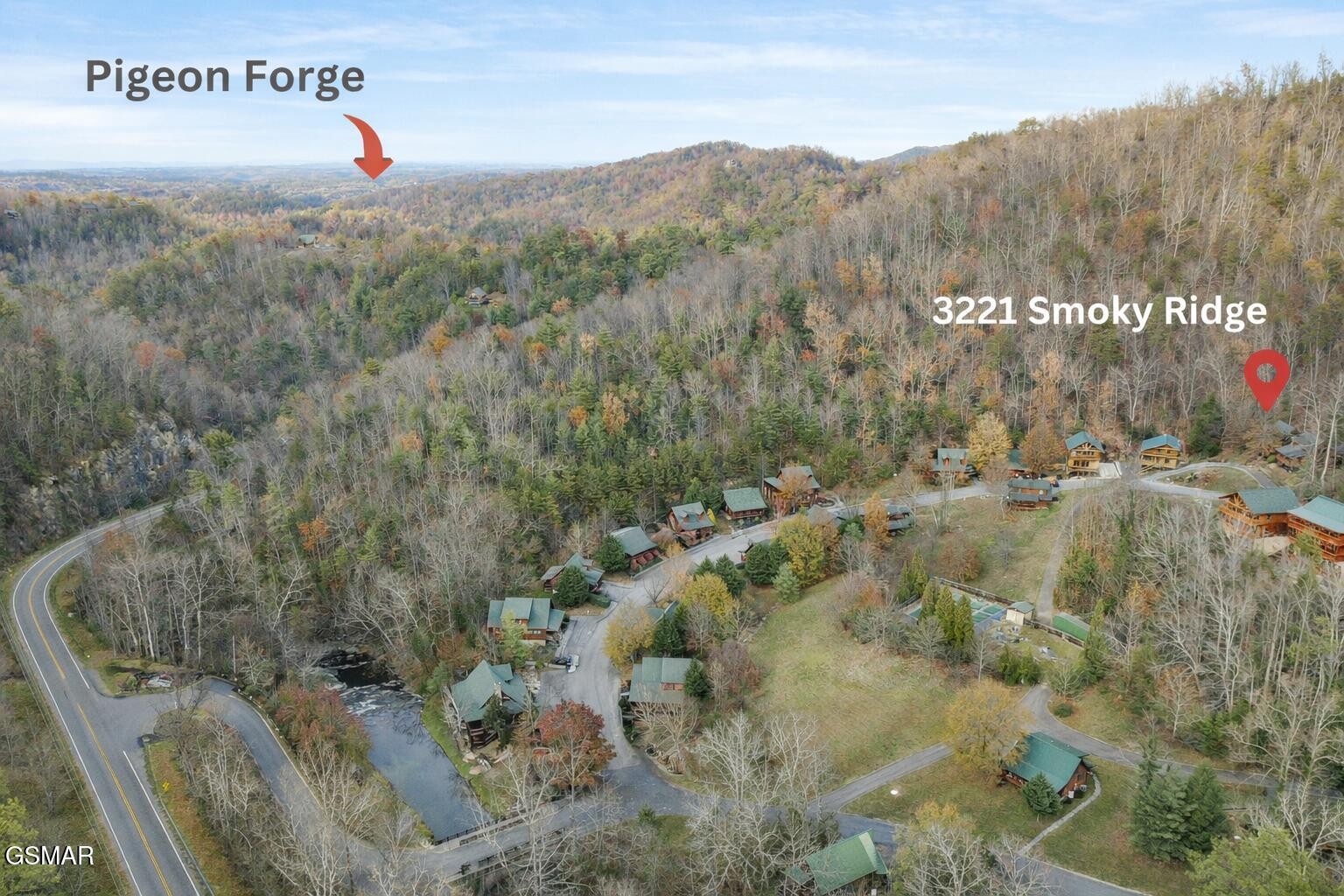 Aerial view of Smoky Ridge cabins among autumn woods, with a red pin marking 3221 Smoky Ridge.