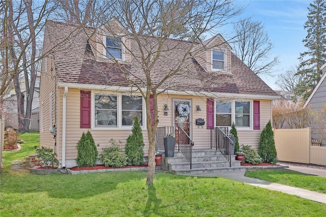 Beige two-story house with magenta shutters, front steps, and a steep shingled roof.