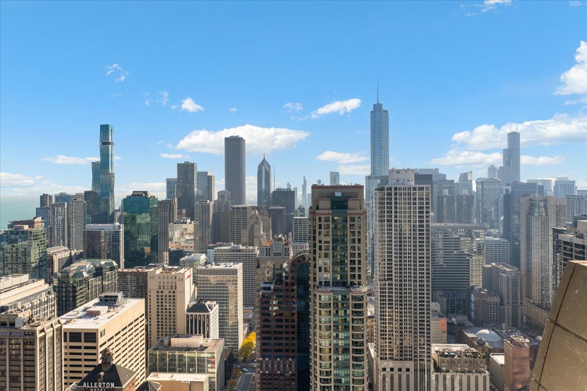 Chicago skyline from a high-rise, with Lake Michigan visible beyond the buildings.