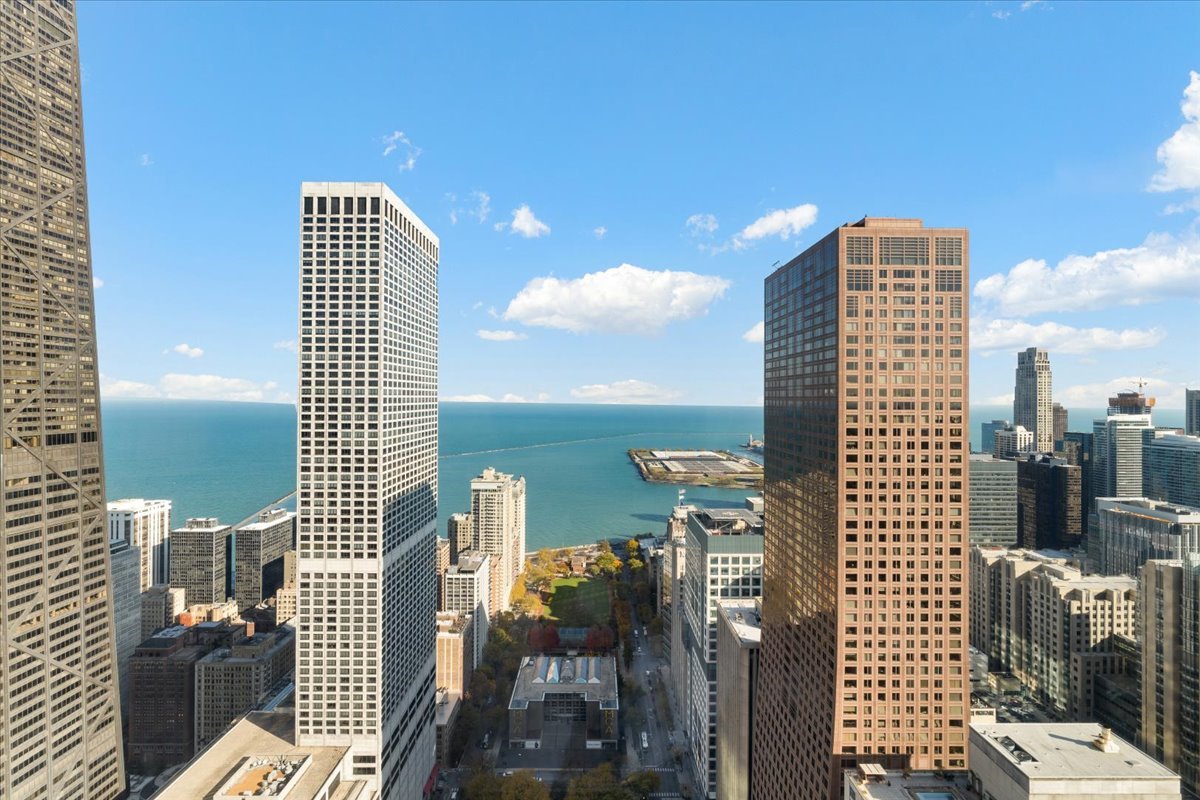 Chicago skyline and Lake Michigan viewed between tall downtown towers.