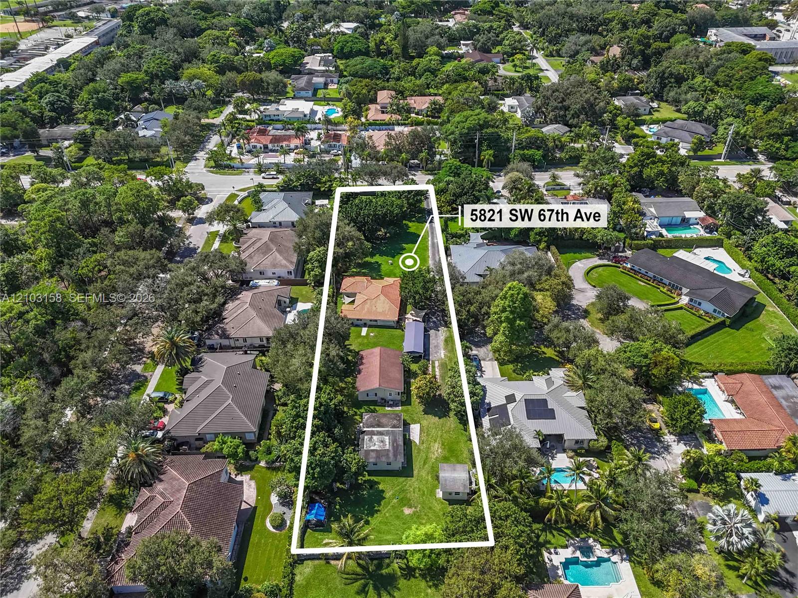 Aerial view of 5821 SW 67th Ave, with the long property lot outlined among tree-lined homes.