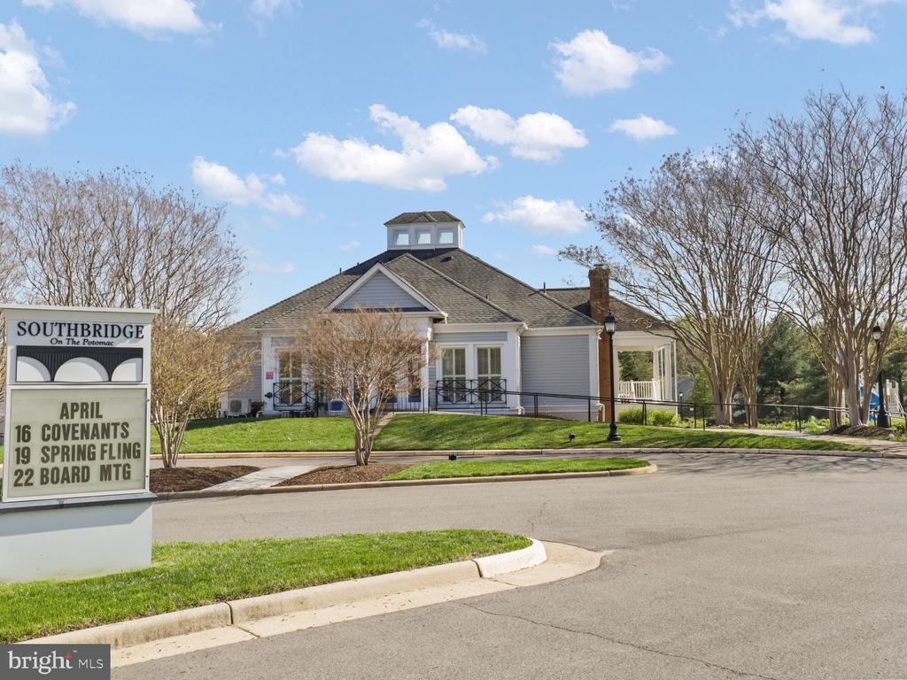 Community clubhouse with a cupola and covered porch, beside a Southbridge on the Potomac events sign.