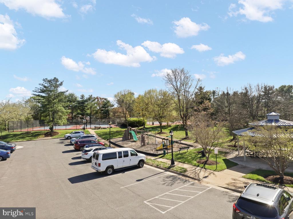Community amenities with a tennis court, playground, pavilion, and parking area.