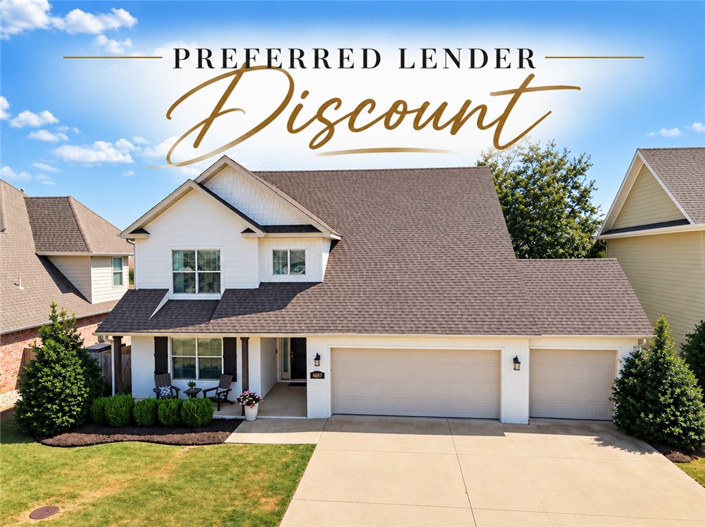 White two-story home with a broad roof and attached double garage beneath “Preferred Lender Discount” text.