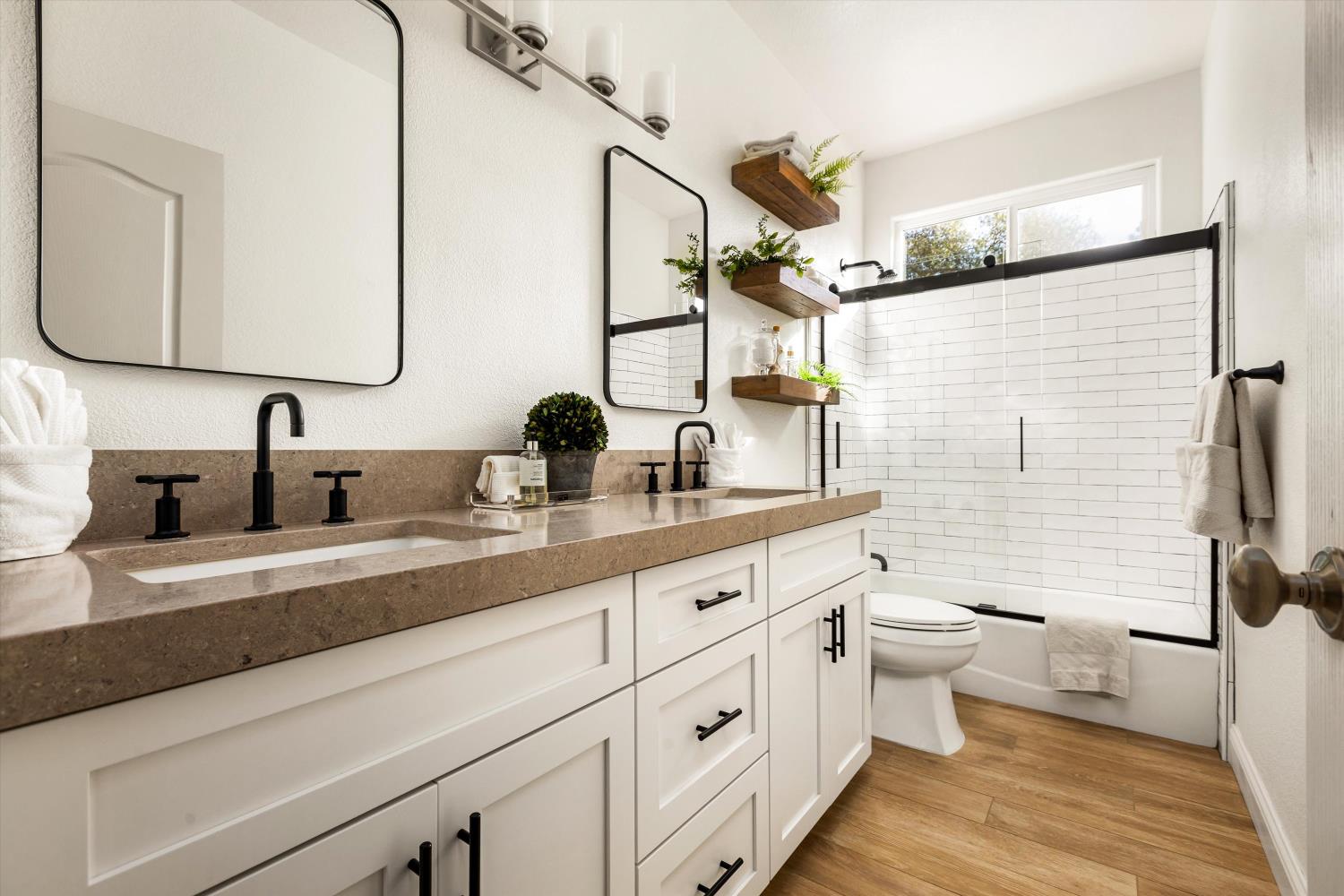 Bathroom with a long white vanity and a white subway-tile tub and shower.