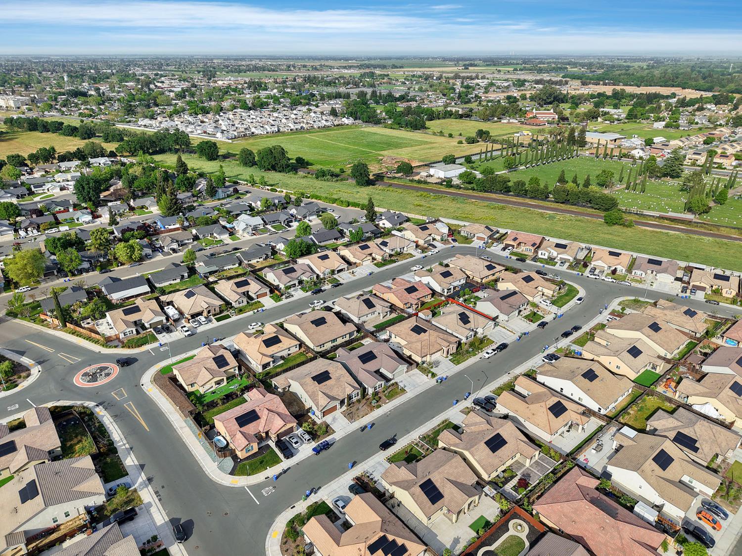 Aerial view of Galt homes, with open fields and a cemetery beyond the neighborhood.