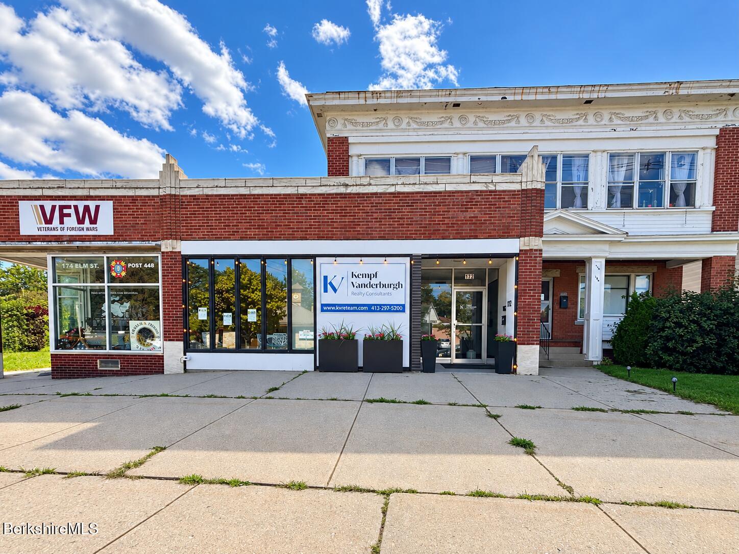 Brick storefront housing Kempf Vanderburgh Realty Consultants, beside a VFW post.