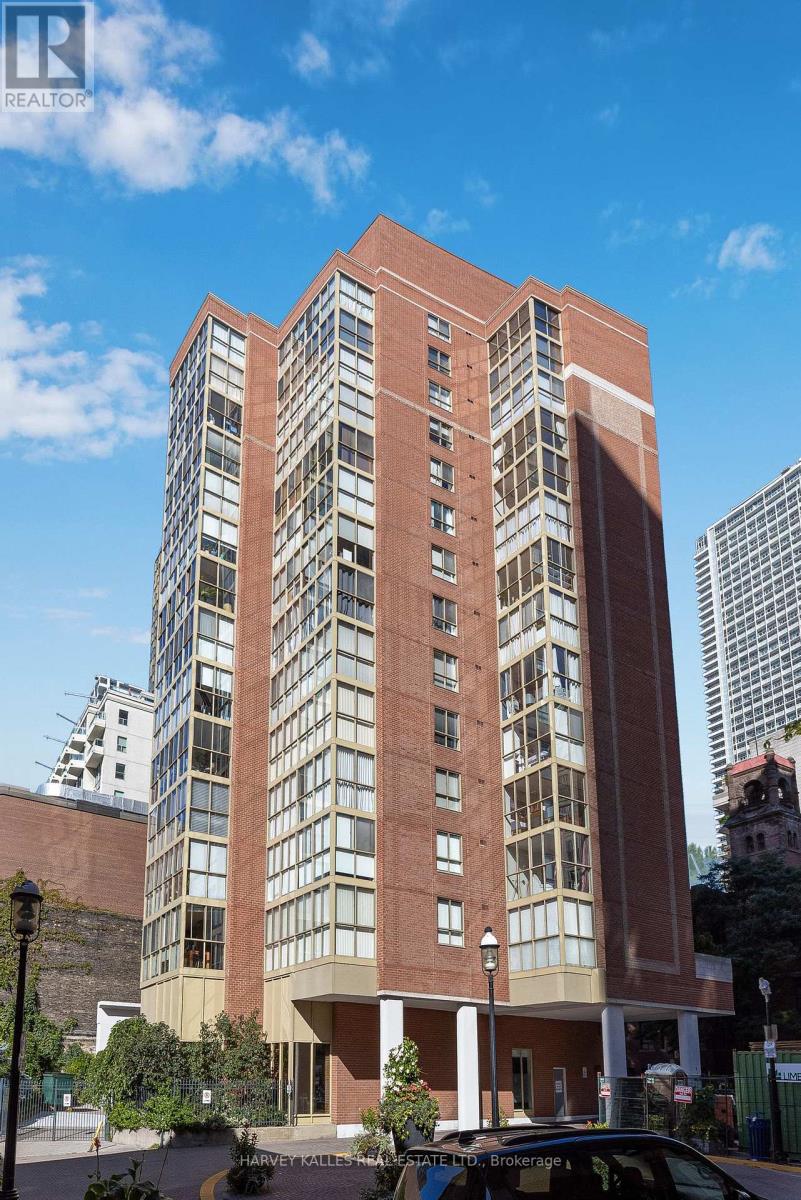 Red-brick condominium tower with projecting glass-window bays on an urban street.