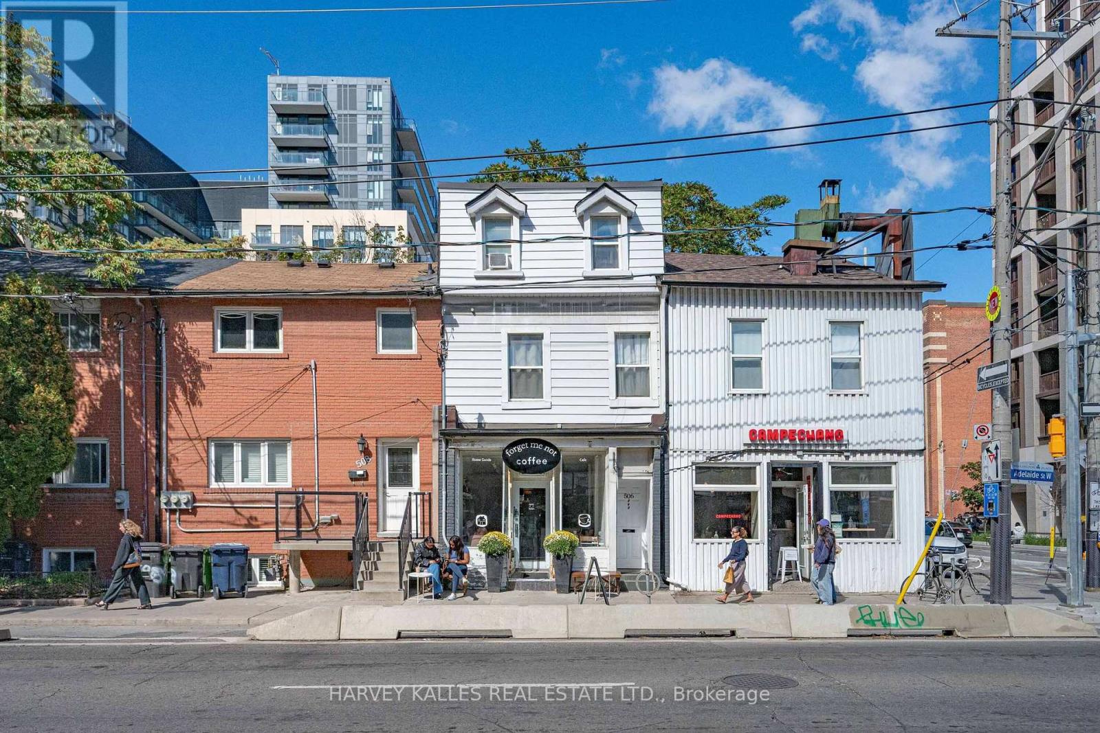 Attached brick and white storefronts on Adelaide Street West, including Forget Me Not Coffee and Campechano.