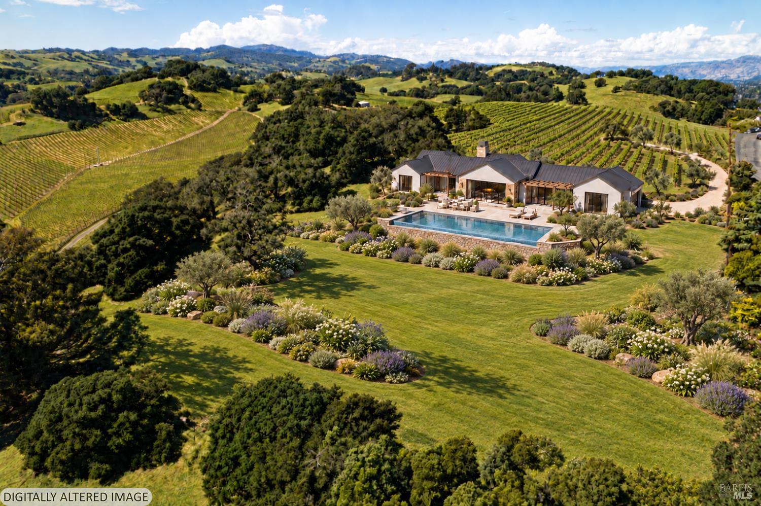 Modern home and pool surrounded by vineyard rows and rolling Napa Valley hills.