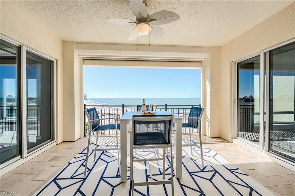 Condominium balcony with a dining table and ocean view.
