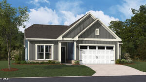 Gray gabled house with white trim, attached garage, and landscaped front lawn.