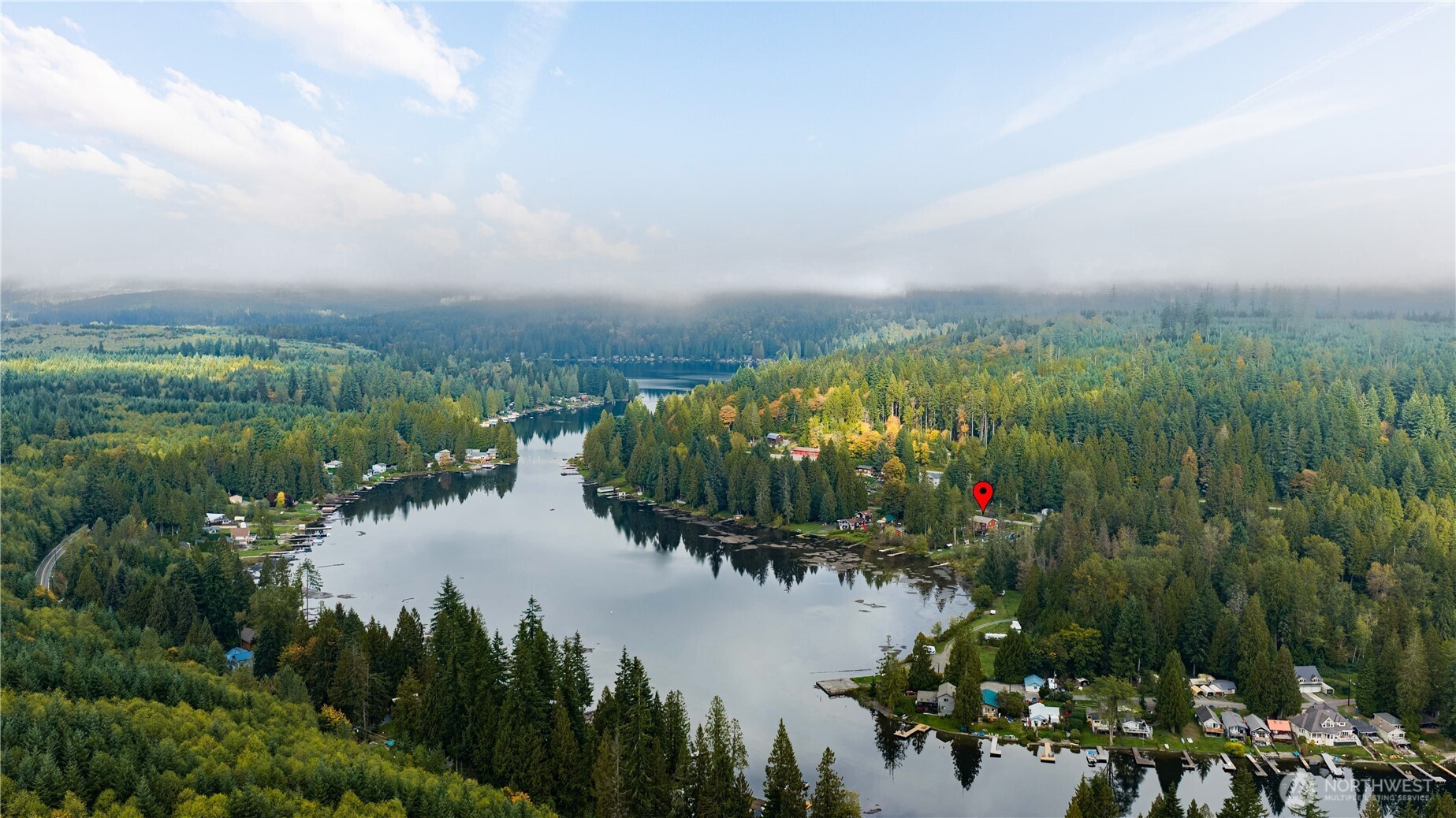Aerial view of Lake Roesiger, with a red marker locating a wooded waterfront property.