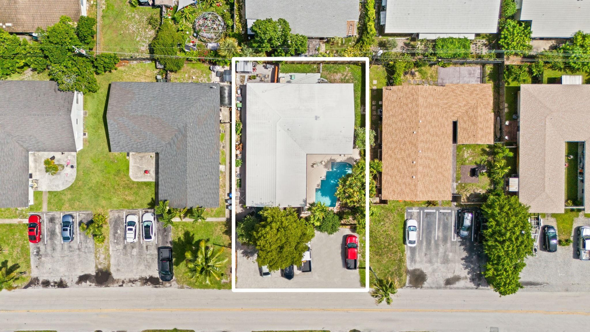 Aerial view of the outlined home and its backyard swimming pool.