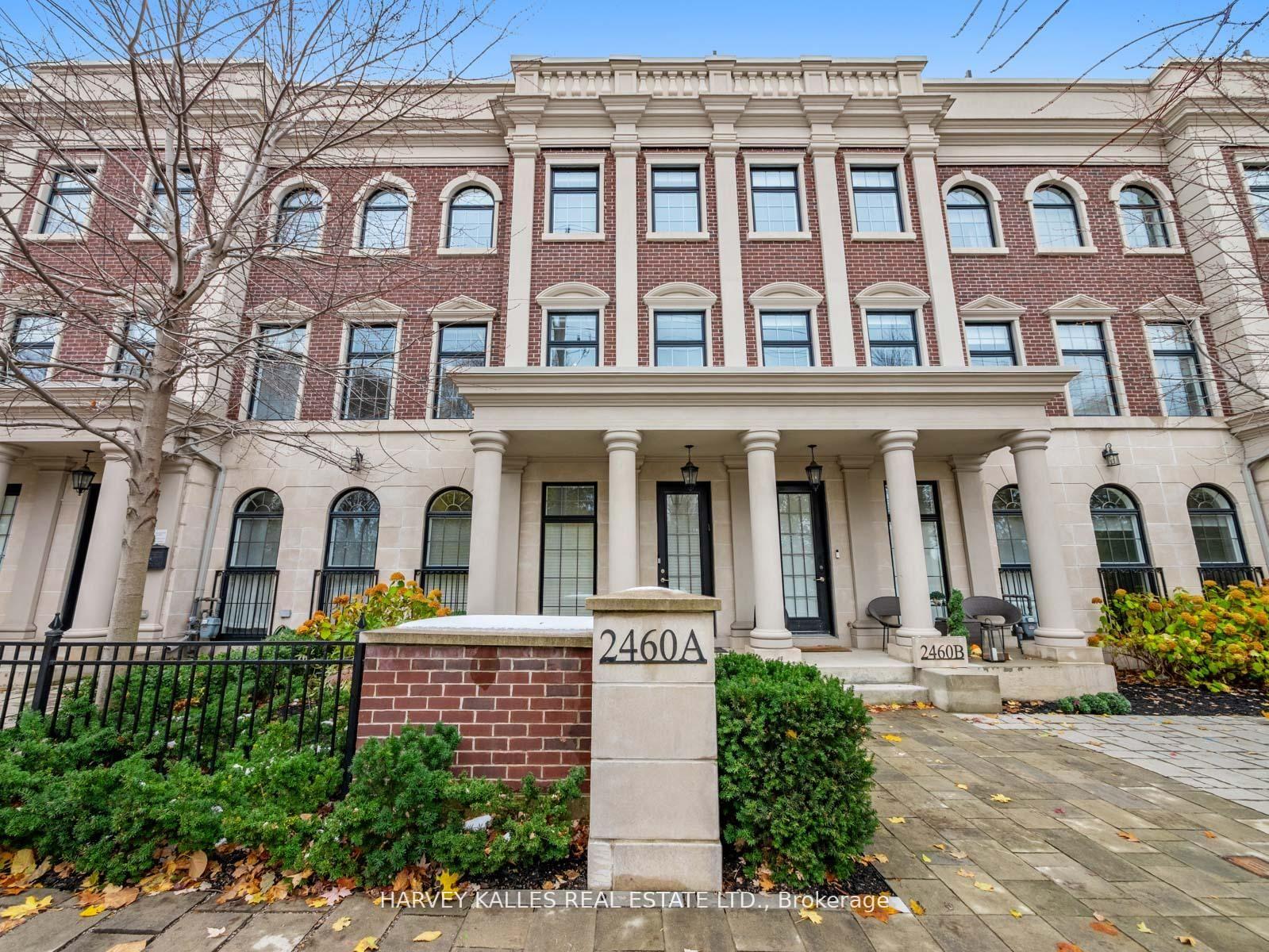 Brick residential building with cream columns, arched windows, and entrance markers 2460A and 2460B.