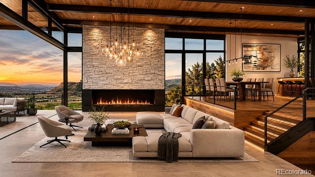 Modern living room with stone fireplace, vaulted wood ceiling, and sunset views through expansive windows.